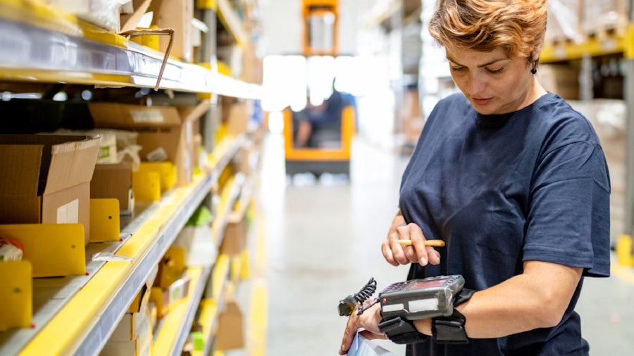 Factory worker checking manufacturing for heavy equipment