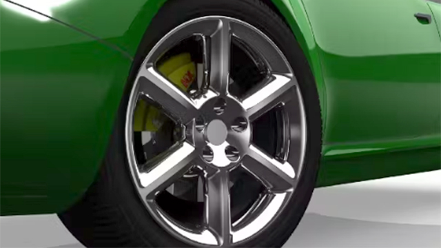 The quarter pannel and wheel of a green car