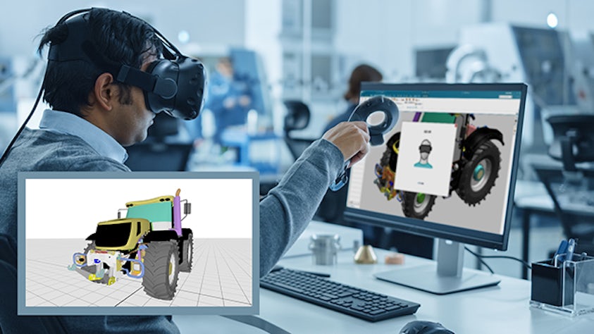 An engineer wearing VR goggles, working on a design for a bulldozer in front of a computer monitor.