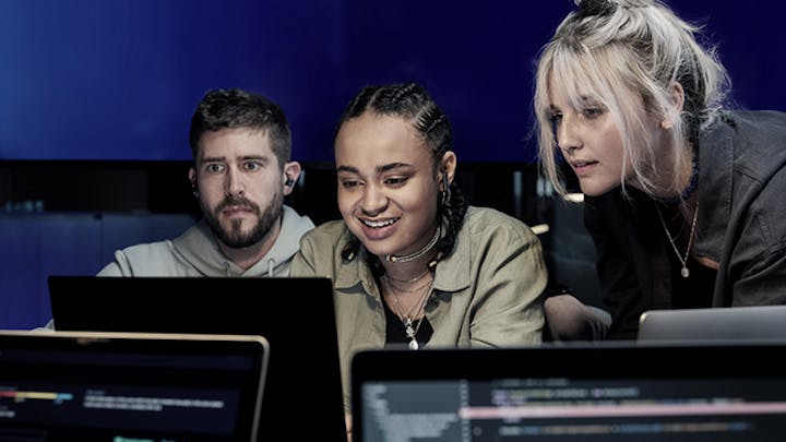 Team collaborating on computers. 