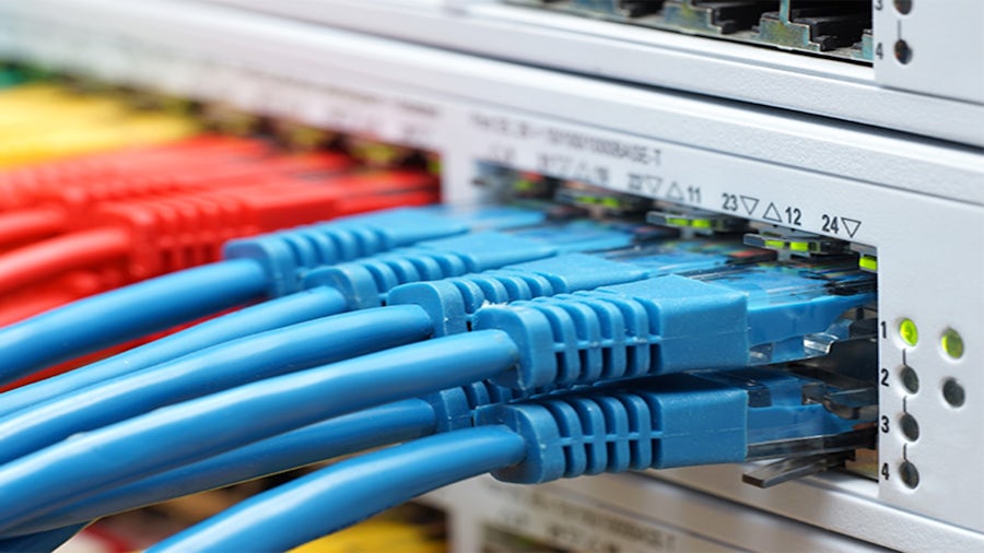 network switch rack with ethernet cables plugged in