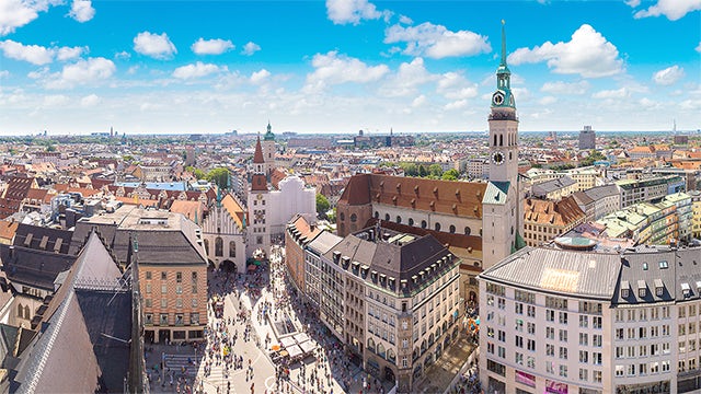 Aerial view of Munich town square during the day. Blue skies.