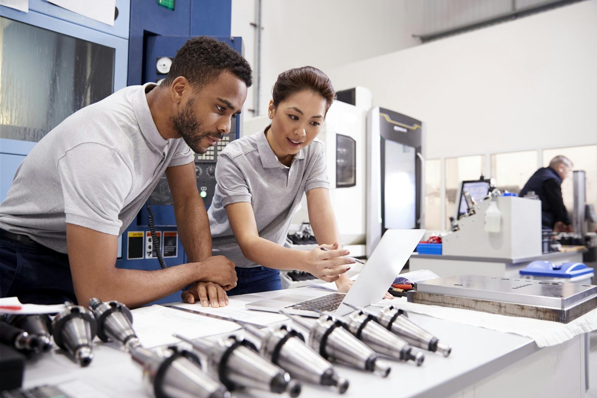 Manufacturing workers collaborating on a job