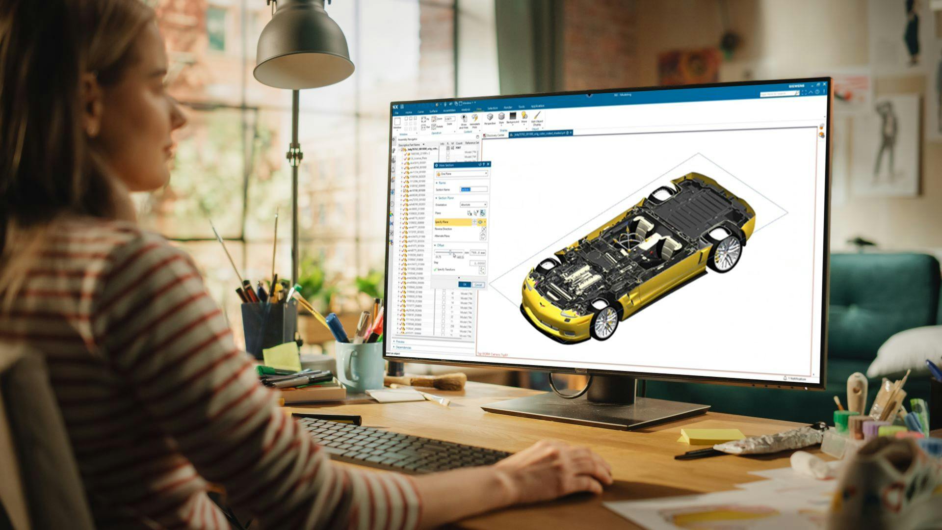Vehicle engineer at her home desk using NX CAD Cloud to enhance collaboration with the product design team