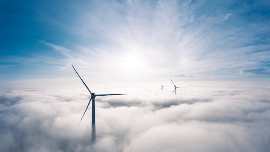 Wind turbines above clouds.