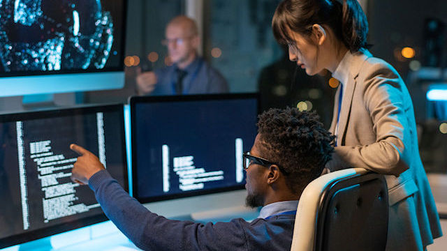 Two engineers debugging software.