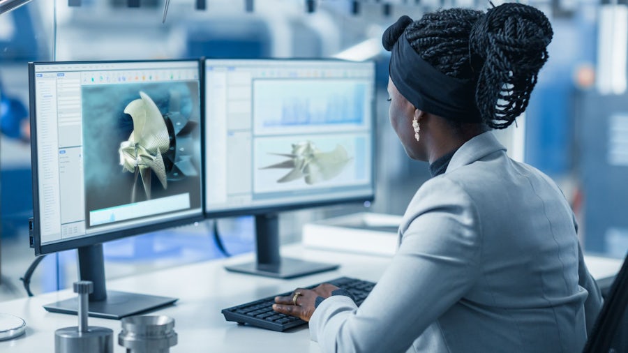 A ship designer assesses a propeller on a computer monitor.