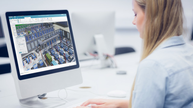 Woman working on computer using plant design and simulation software.