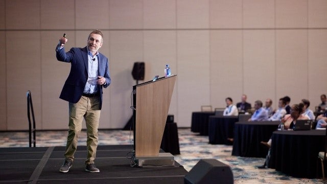 A speaker gives a product demonstration at the Siemens Realize LIVE digital transformation conference.