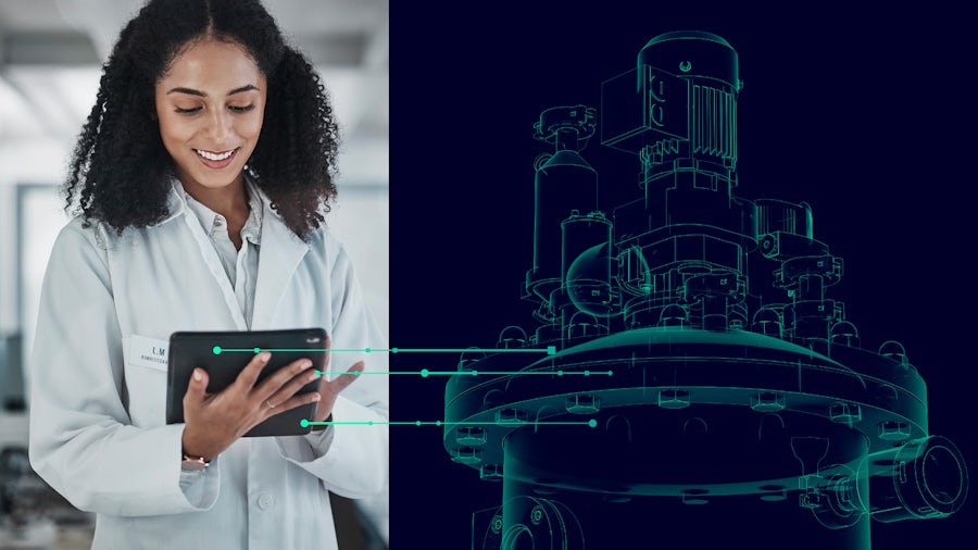 Scientist in a white lab coat that is holding and looking at a tablet.