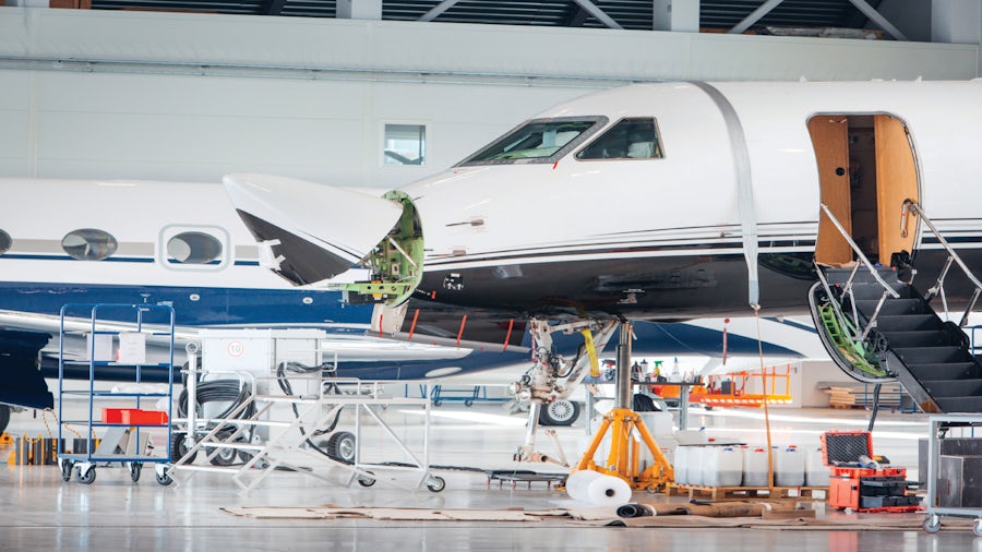 Airplane in hanger being worked on.