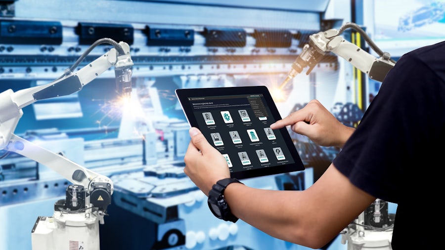 A man who uses a tablet in production control