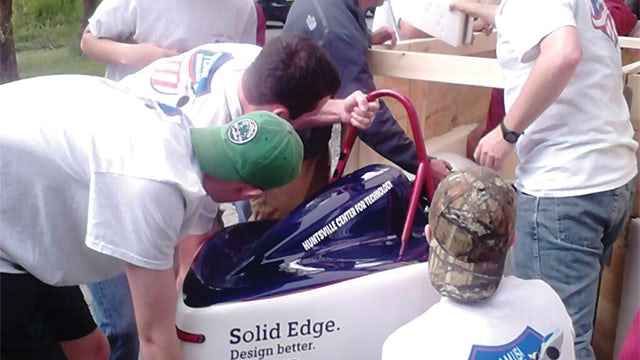 Unpacking a precious cargo: the team carefully removes their car from its shipping crate ready for scrutineering.