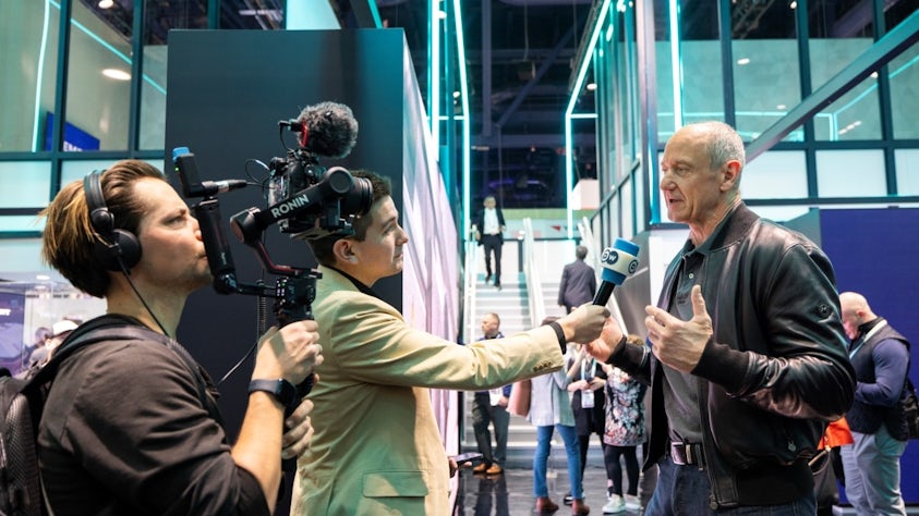 On CES 2024 Media Day, a reporter and his videographer interview Siemens Chief Executive Officer Roland Busch.