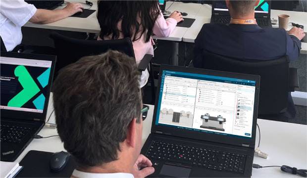 Professional working on product configuration software, viewing technical drawings and specifications on a laptop screen in a modern office environment.