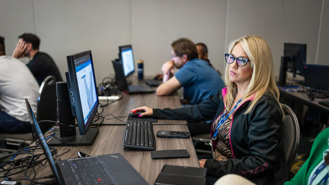 Three individuals in a hands-on training session at Realize LIVE.