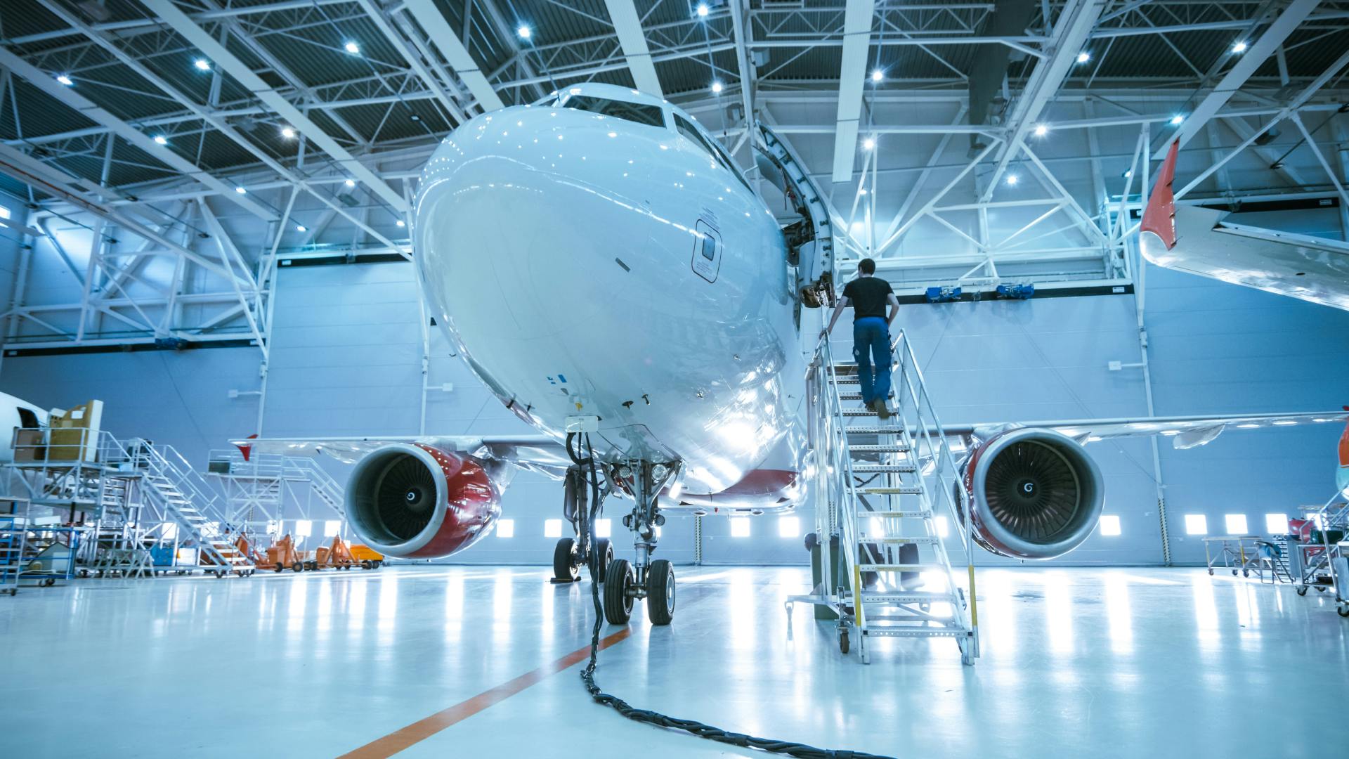 A commercial aircraft being serviced in a hangar.