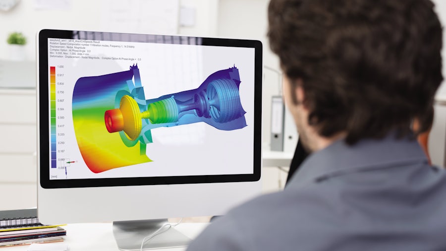 Engineering looking at a computer screen showing a rotor dynamic simulation of a jet engine.