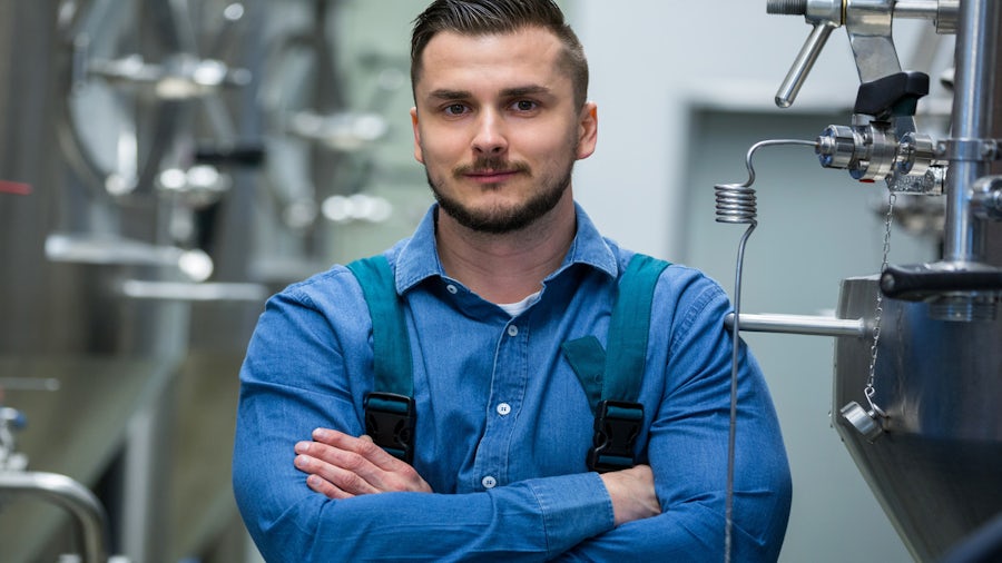 Worker standing in a process manufacturing facility. 