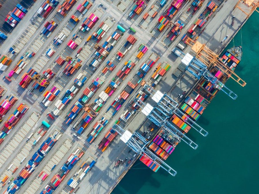 Aerial view of a container ship in a container terminal port representing the need for supply chain resilience