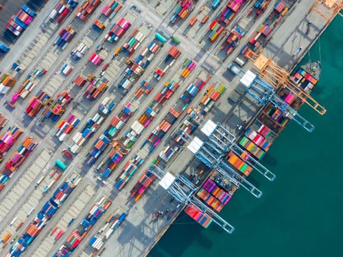 Aerial view of a container ship in a container terminal port representing the need for supply chain resilience
