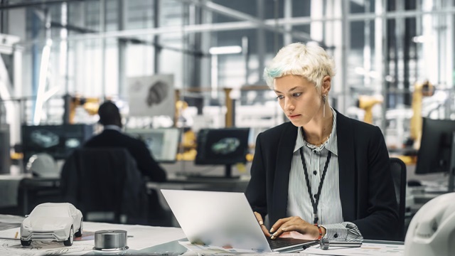 Woman working on a computer in an office.