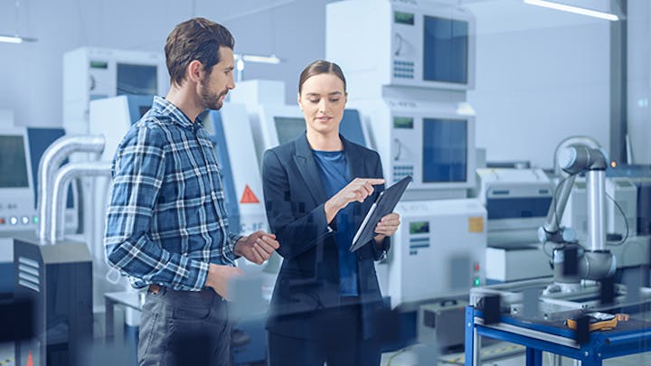 Image of a man and woman working in a lab setting. The woman is holding a tablet and sharing data with the man. This image is meant to illustrate the concept of closed-loop quality.