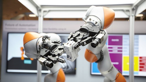 Two robotic arms holding object