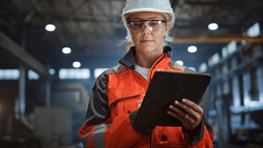 Engineer reviewing complex heavy equipment data