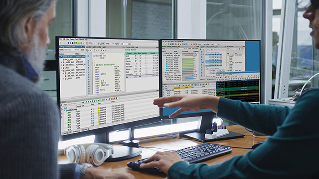 Two engineers view the Siemens Questa Coverage tool and discuss the data.