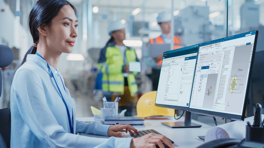 Worker utilizes Teamcenter Quality software on her workstation. 