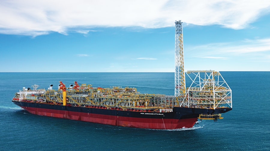 a cargo ship out at sea with a deck full of shipping containers. 