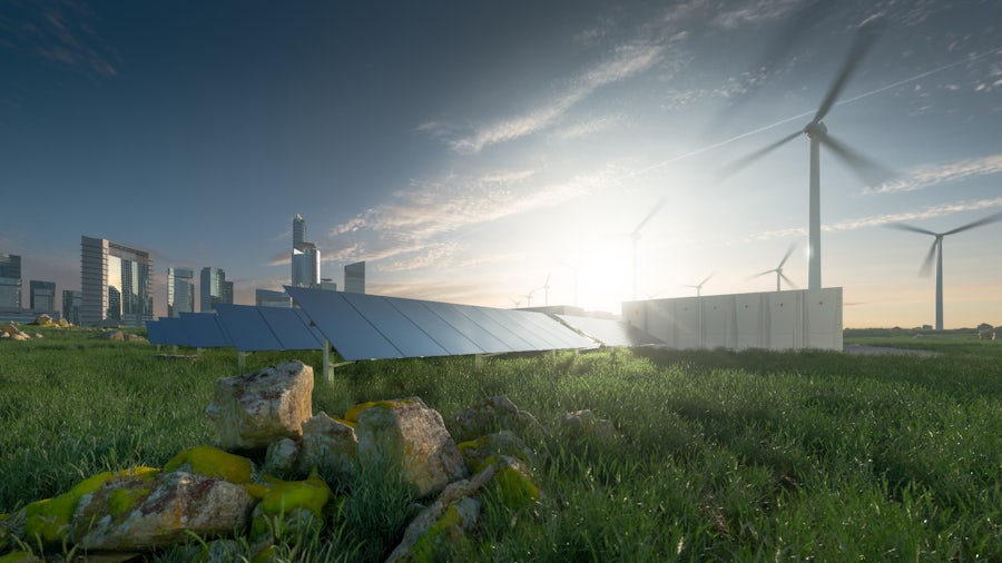 A factory manufacturing batteries, with solar panels collecting sustainable energy