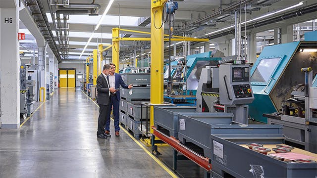 Two people working in a machine shop