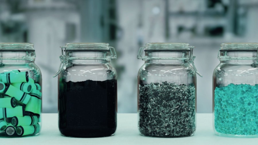 Three jars filled with colorful contents in various shades, arranged side by side on a flat surface.