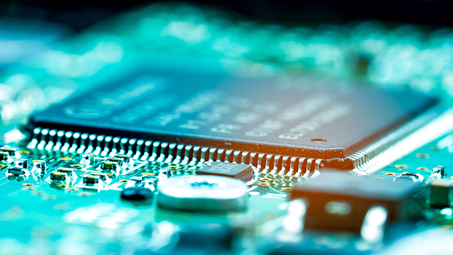 side angle of chip on board with green background