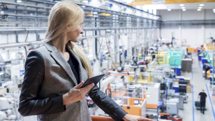 A woman overseeing the industrial quality testing in a warehouse.