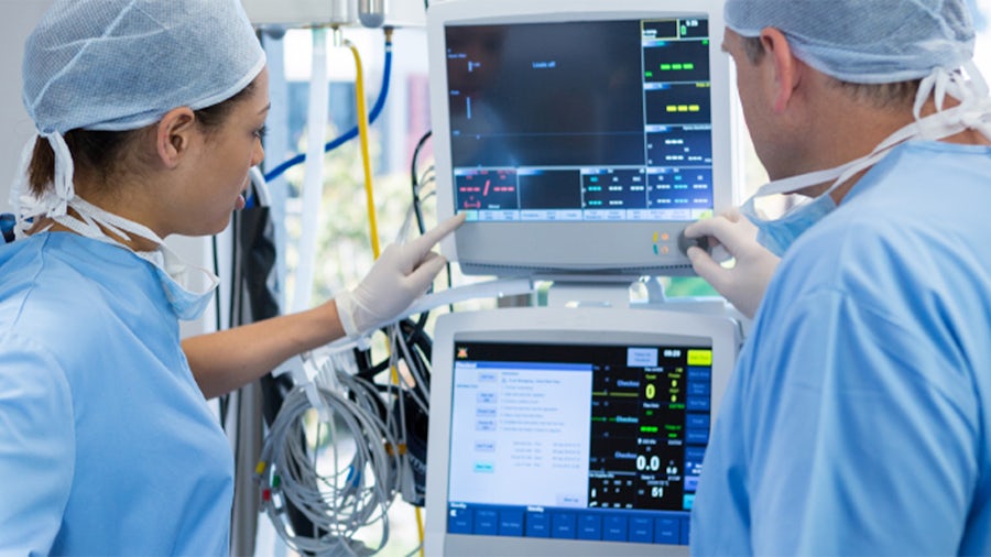 Two doctors using looking at a medical device screen