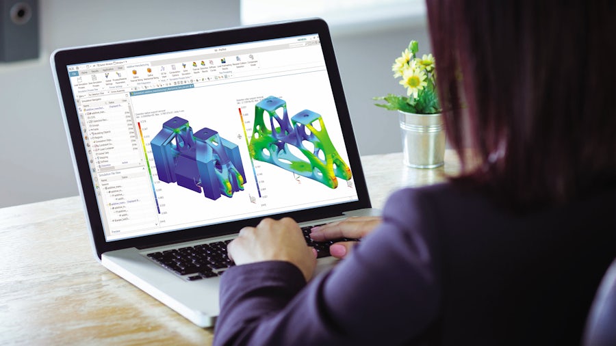 Engineer simulating and optimizing a bracket to be printed right the first time through industrial additive manufacturing.