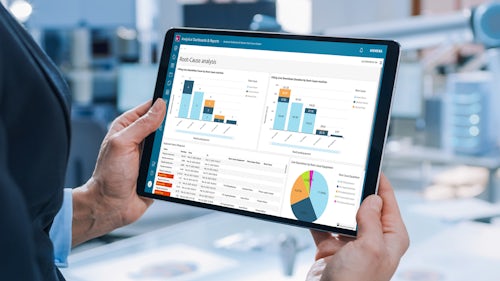Person holding a tablet displaying manufacturing data analytics using Opcenter Intelligence Cloud SaaS software. 