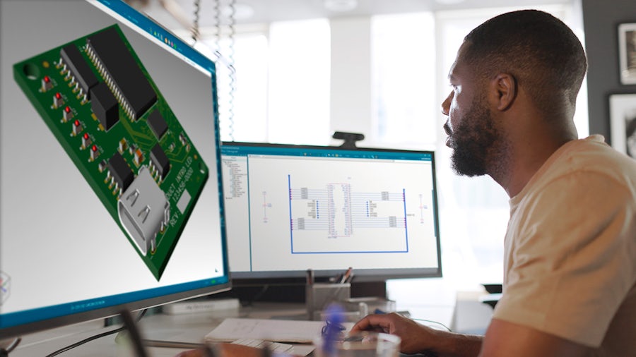 An engineer looking at two monitors showing PADS Pro Essentials software.