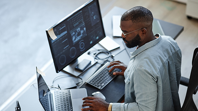 man working on computer at desk