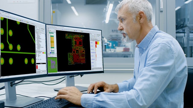 Man using Valor solutions to optimize PCB design/manufacturing with a complete digital-twin flow.