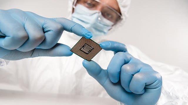 Person holding a semiconductor.