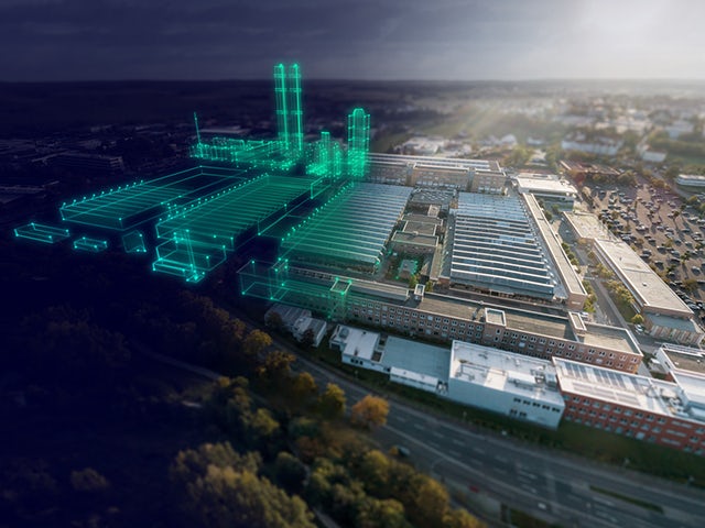 An aerial view of a factory campus with a blue "digital twin" overlay.