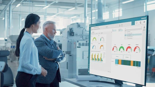 Two manufacturing executives look at a personalized dashboard for their manufacturing execution system (MES).