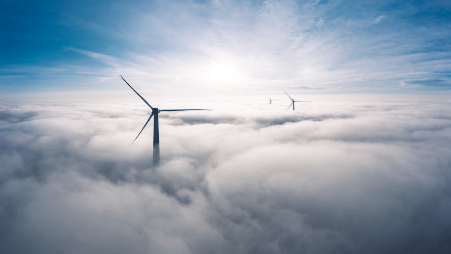 A wind turbine above the clouds. 