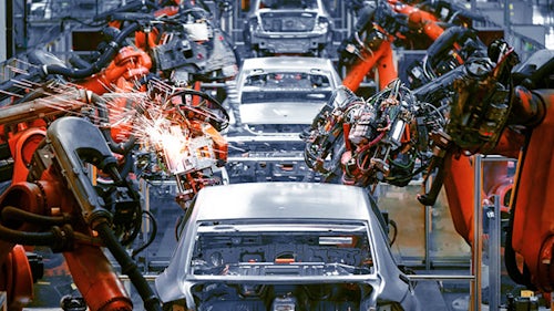 Robots building cars in a car factory