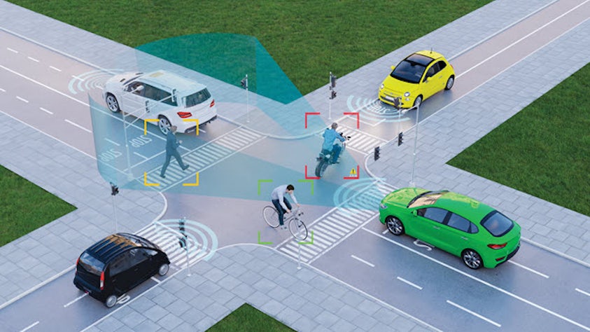 Smart intersection demonstrating connected vehicle technology detecting multiple road users with visual representation of sensor coverage and safety monitoring zones.