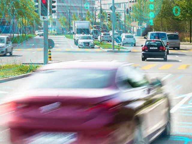 Cars driving through traffic signals.